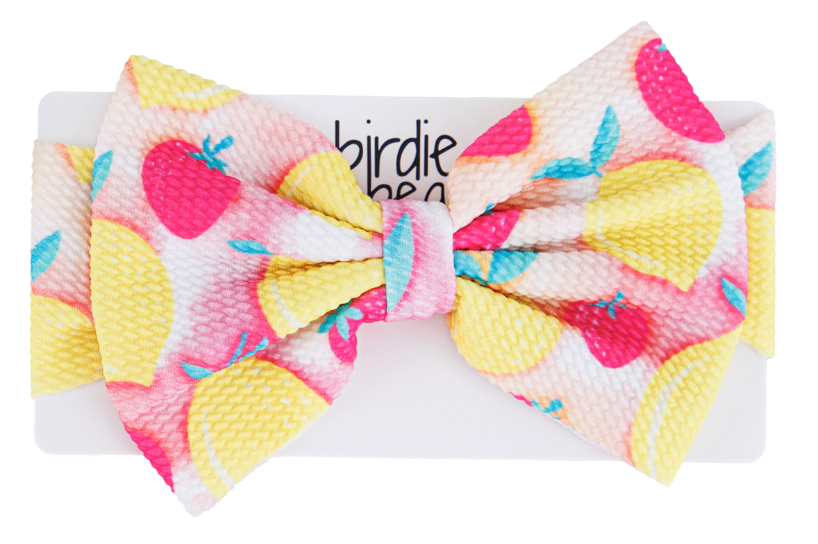 Colorful bow with lemons and strawberries on a white background